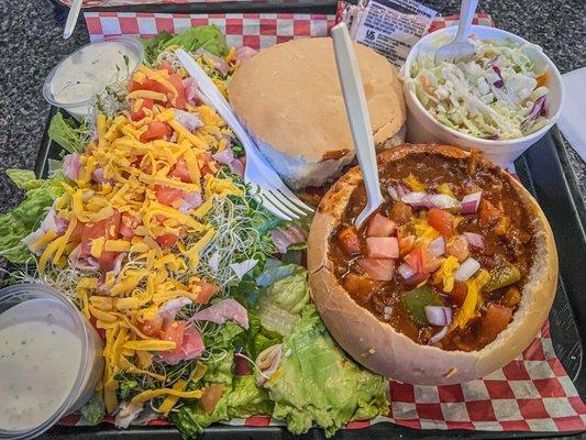 Chef salad, chili in bread bowl and cole slaw.