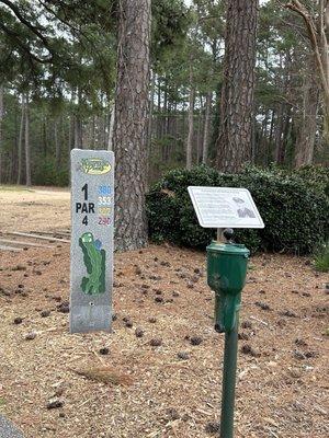 Signage shows hole layout and yardage