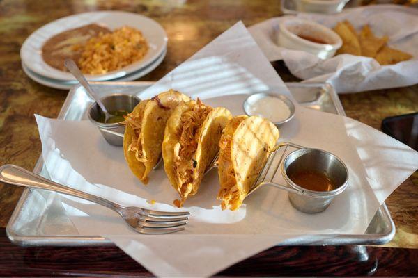 Chicken tinga tacos. Will order these again. Side of rice and beans in the background.