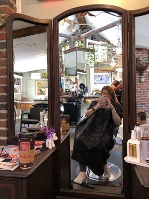 Marty's Salon through the antique looking stylist station mirror