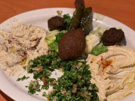 It is called Mazza has a little of everything hummus baba guan pigs grape leaves tabbouli kibbeh and falafel a must try dish