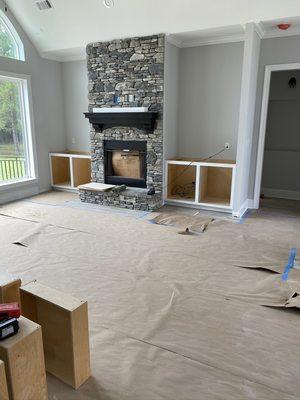 The fireplace stone veneer and mantle are completed