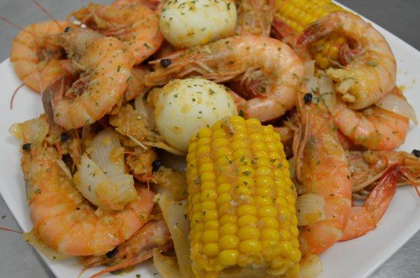 Boiled Jumbo Shrimp add Corn, Boiled Eggs, and onions tossed in House Butter.