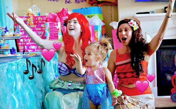 Two princesses singing with the little birthday princess!