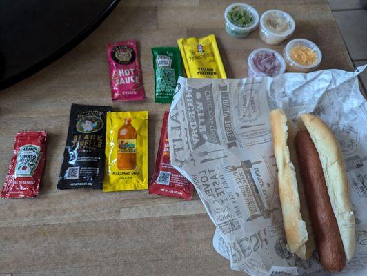 Beef hot dog with toppings and condiments