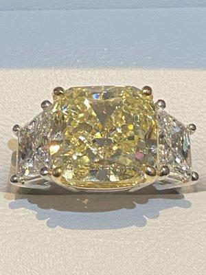 Yellow diamond ring with white diamonds, set in platinum and 18k gold.