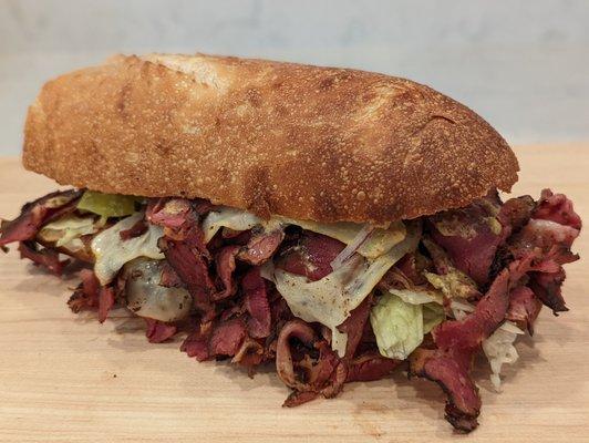 CRUST HOT PASTRAMI - Double Pastrami, melted cheese, pepperoncini, lettuce, onions, spread. Exclusively at CRUST San Jose