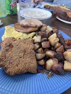 Country fried steak and eggs with sausage gravy. Delicious.