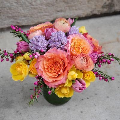 Petite spring low and lush with free spirit roses, spray roses, lavender hyacinth and ranunculus.