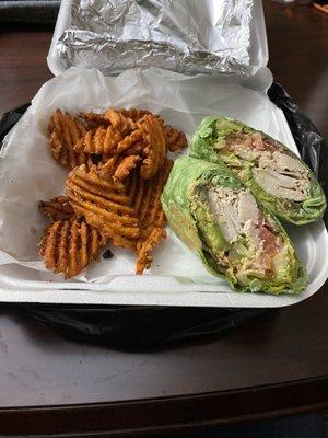 Turkey avocado Wrap with sweet potato waffle fries.