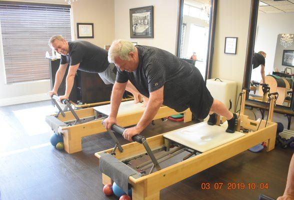 Men doing plank with pushups