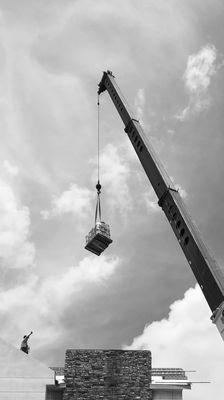 Crane loading a roof