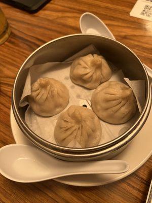 Soup dumplings. Eat it in the spoon. They leak and are super hot (temp), but so delicious!