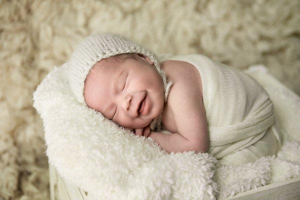 Smiling newborn baby photographed by Van Buren Photographer.