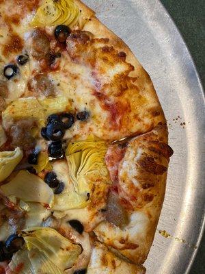 Artichoke, black olive, and Italian sausage pizza.