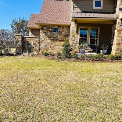 Trimmed all landscape, planted new plantings, mulched beds & fixed sprinkler system.