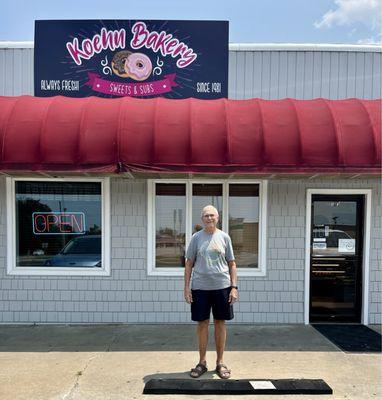 Satisfied customer outside Koehn's family bakery & sandwich shop