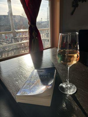 My favorite seat here, wine, perfect lighting, and a good book !