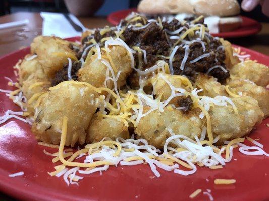 Tater tots covered in cheese and chili.