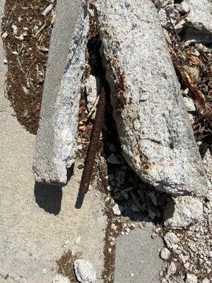 Curb, broken with rebar exposed