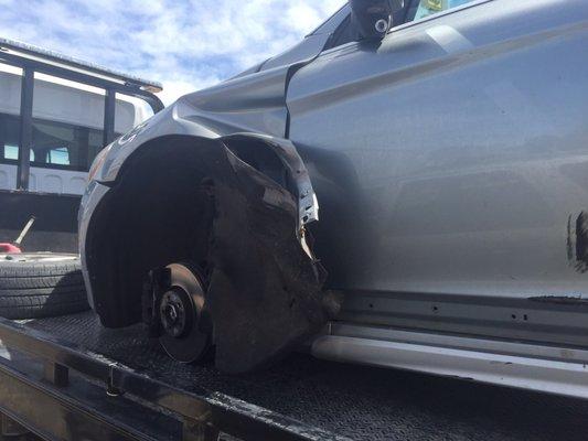 Car after wheel installed by Hayes Automotive flew off the car while driving on the highway