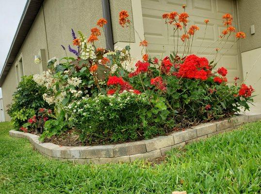 Double stacked pavers around flower bed