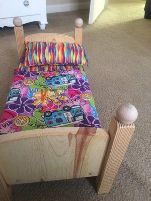 Sturdy wooden Doll bed with cool linens