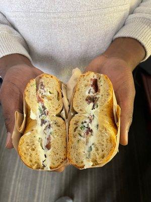 Parmesan pepper bagel with pastrami lox, bacon, with chive cream cheese (he requested light on the cream cheese)