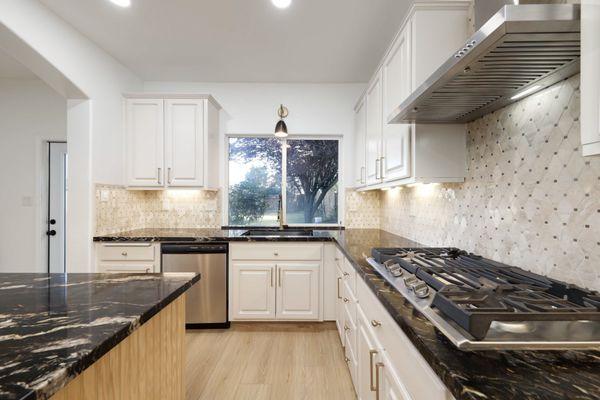 Kitchen update with new island, countertops, mosaic backsplash and the perfect taupe cabinets.