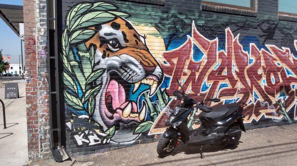 Lance Cabo 125 with Larimer St. wall art.