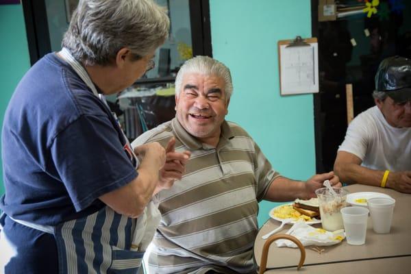 A volunteer and guest share a special moment.