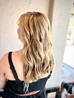 We added warm roots and warm lowlights to this blondie.