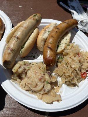 2 sausage platter with sauerkraut and potatoes