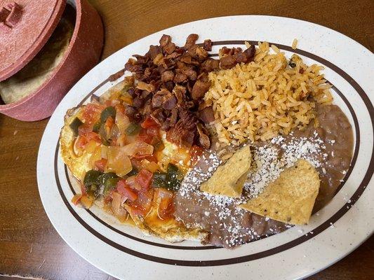 Huevos rancheros combination plate with a side of bacon