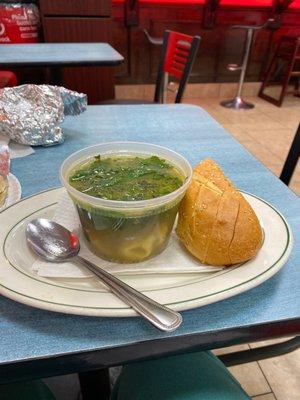 Tortellini en brodo soup with fresh herbs and soft Italian bread.