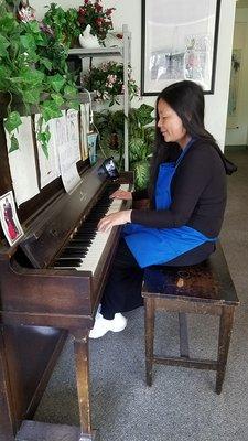 Huiya Chen, Owner, at her piano. Not often do we see her play but her CD's are usually on the stereo.