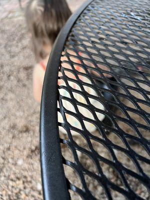 The gravel dirt floor with terrible metal patio furniture.