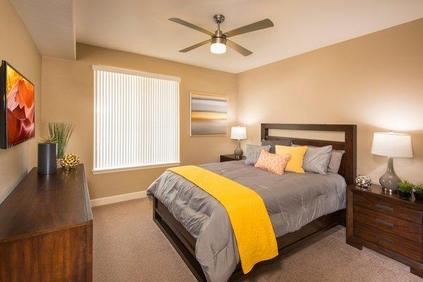 Bedroom with lighted ceiling fan at Southern Ave Villas