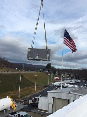 Setting a rooftop unit on a perfect-weather day!