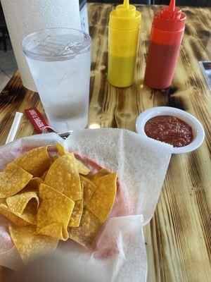 Chips with a nice thick salsa. Ketchup and mustard bottles contain green and red hot sauce