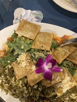 Vegetarian ravioli on a bed of julienned vegetables with slivered almonds. One of the courses served at the wedding dinner.