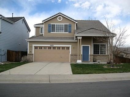 The white trim on this older home sets the perfect contrast against the tan siding and brickwork.