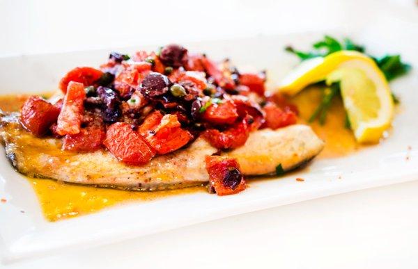 Branzino with diced tomatoes, Gaeta olives and capers in lemon and white wine sauce