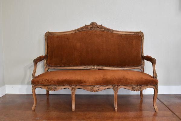 Rich suede upholstery subtly enhances the luxurious appeal of this French bench.