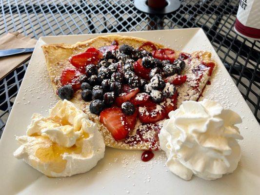 Berry crepe with a honey raspberry drizzle and honey infused Greek yogurt.