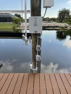 Boat lift controller at a dock in Sarasota, FL. 30 amp 240 volt conduit and wiring on GFCI breaker. Also shown WP outlet.