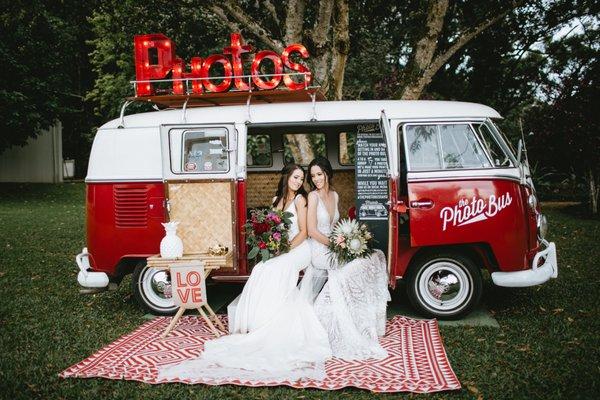 Two beautiful brides share a moment in their Oahu Photo Bus at Sunset Ranch Hawaii