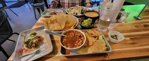 Clockwise (from 12 o'clock) : Potato w/ Chorizo | Queso Dip | Guacamole | Pozole | Ceviche Tostada | Chips | Torito (left of potato)