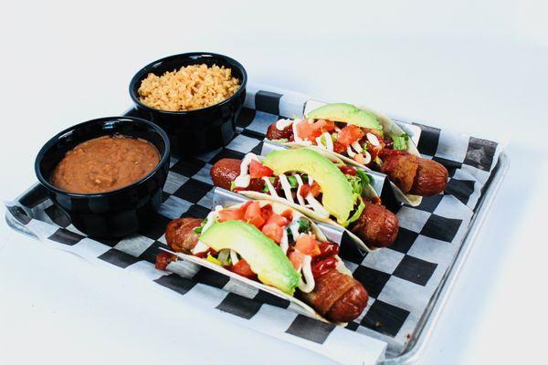 Road Dog Tacos - flour tortillas with bacon wrapped hot dog. Topped with lettuce, tomatoes, avocado slices, ketchup and mayo.