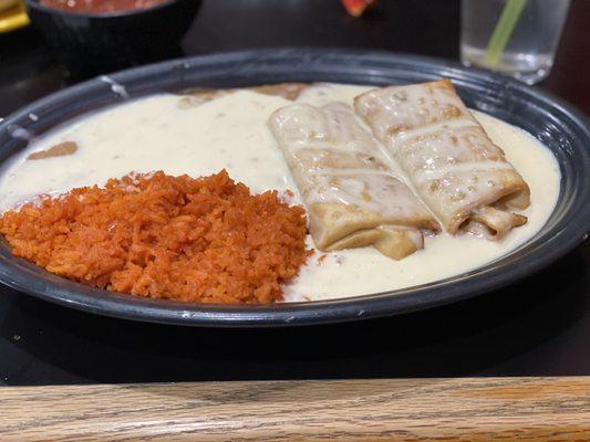 Chicken Chimichanga,Rice,Beans, and of course they're wonderful white cheese all over!!